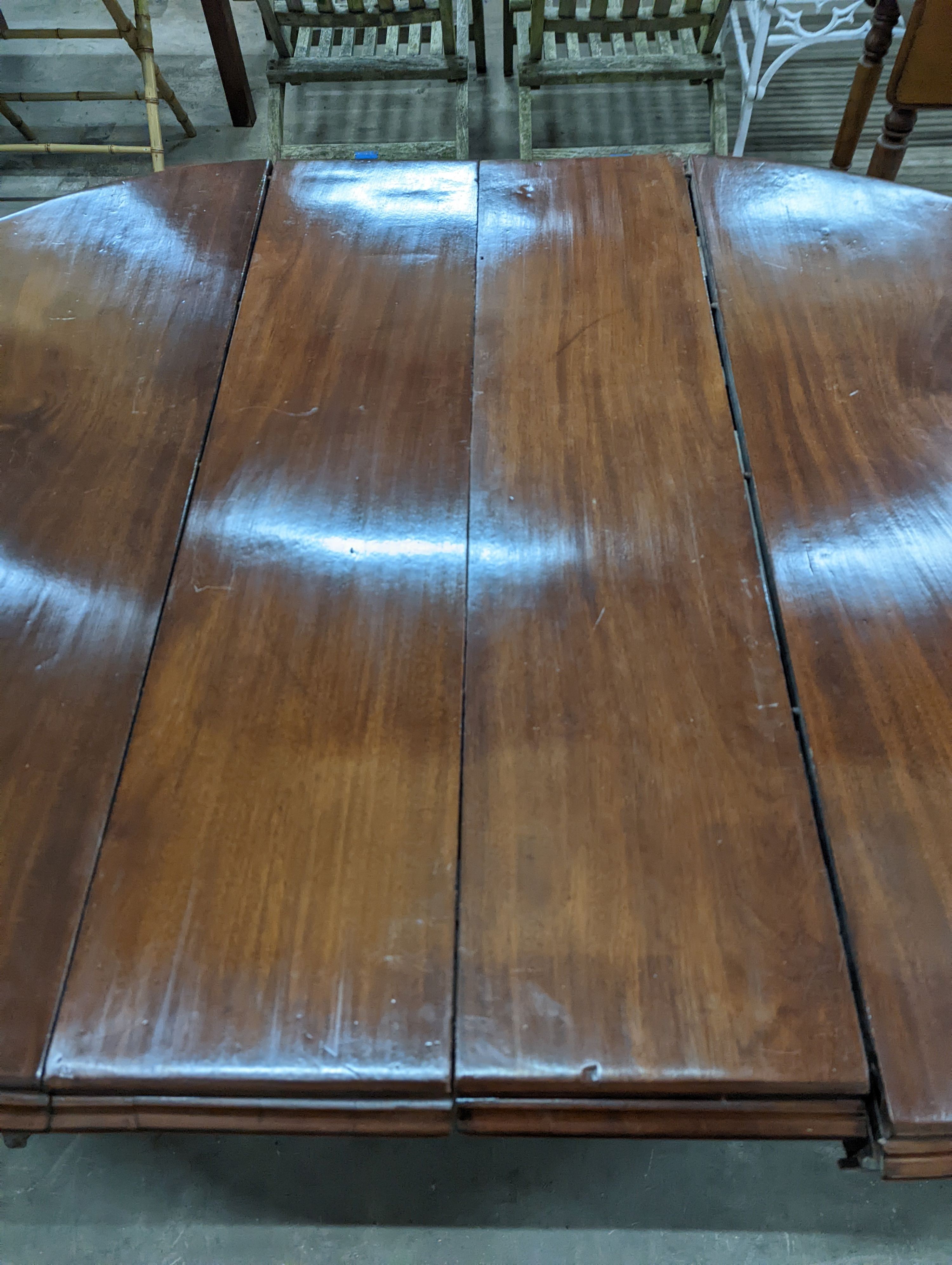 A Victorian mahogany extending dining table, length 170cm extended (two spare leaves), width 119cm, height 71cm